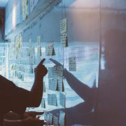 Man pointing to sticky notes in office as part of strategy