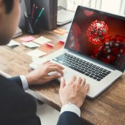 Laptop computer displaying coronavirus macro shot