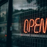 an open sign behind wire