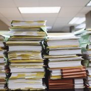 Stack of books and files on table