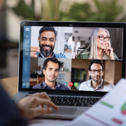 Woman teleconferencing with others via computer.