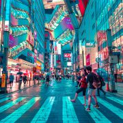 people walking across a crosswalk in tokyo