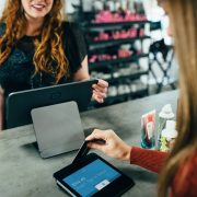 Woman paying using credit card and card reader